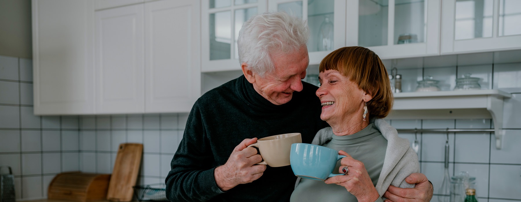 Couple having coffee in their kitchen 