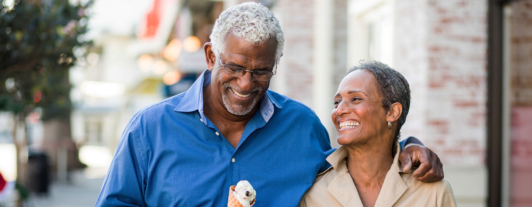 Couple walking down the street eating ice cream